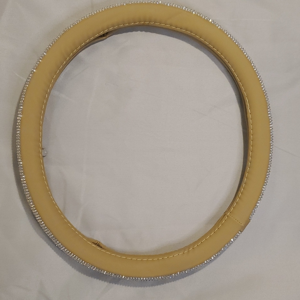 Bling/jeweled steering wheel cover. Tan on inside. NWOT